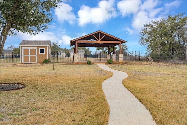 view of yard featuring a storage shed, a gazebo, an outdoor structure, and fence