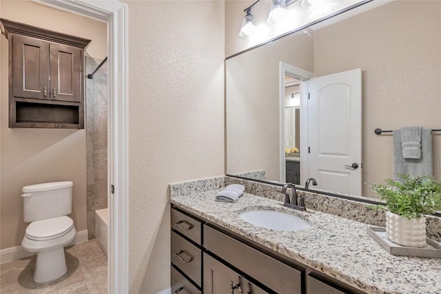 full bath featuring tile patterned flooring, toilet, vanity, baseboards, and tub / shower combination