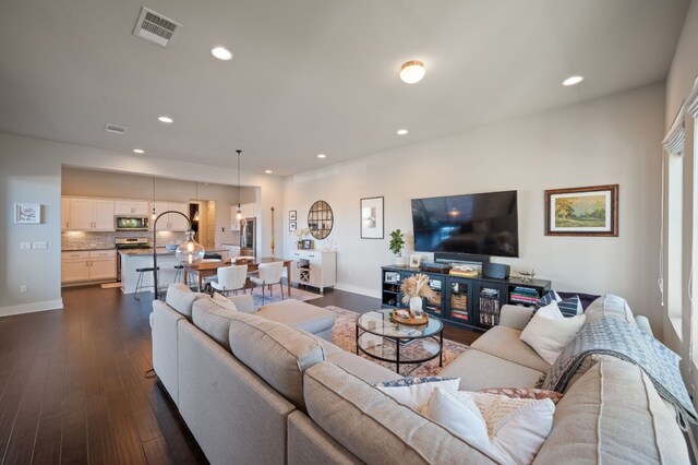 living room with dark hardwood / wood-style flooring