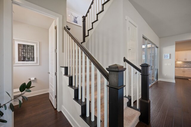 staircase with hardwood / wood-style flooring