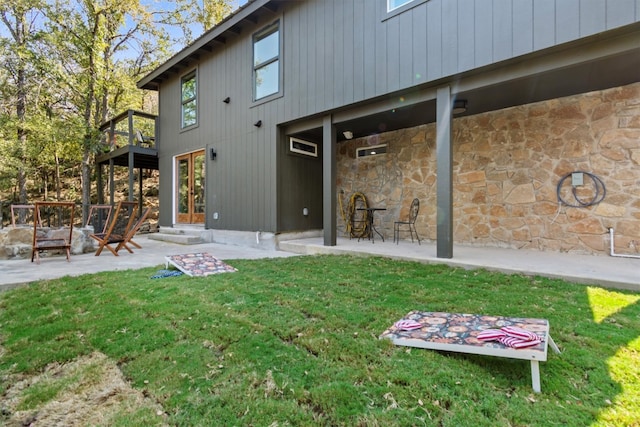 rear view of house with a yard and a patio