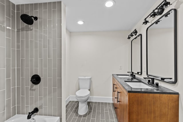 full bathroom with vanity, toilet, and tiled shower / bath