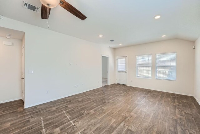 spare room with vaulted ceiling, dark hardwood / wood-style floors, and ceiling fan