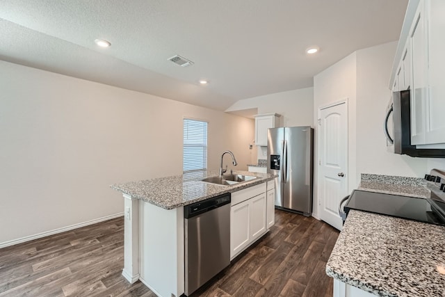 kitchen with white cabinetry, appliances with stainless steel finishes, sink, and a center island with sink