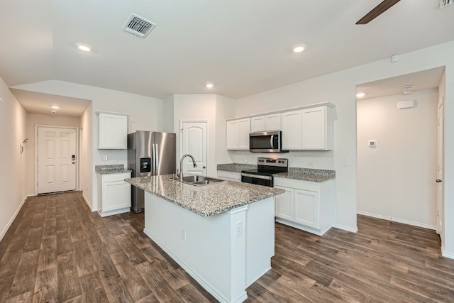 kitchen featuring an island with sink, sink, white cabinets, stainless steel appliances, and light stone countertops