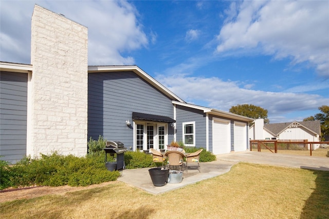 back of house with a lawn