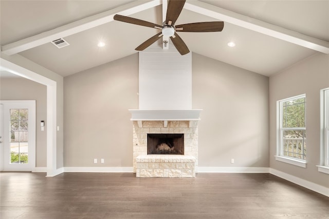 unfurnished living room featuring beam ceiling, ceiling fan, a fireplace, and dark hardwood / wood-style flooring