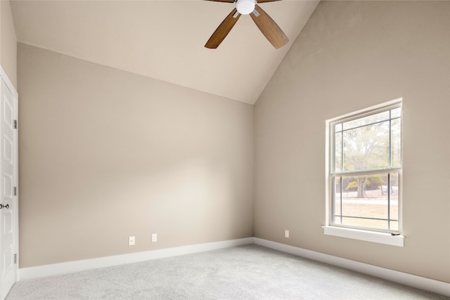 carpeted empty room with ceiling fan and lofted ceiling