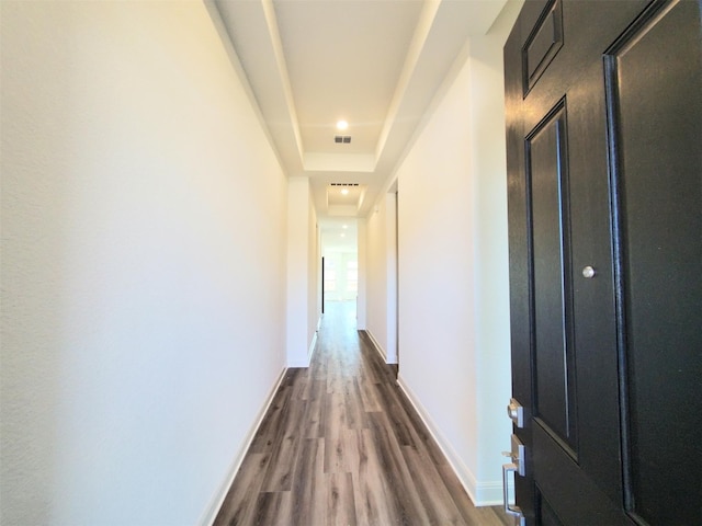 corridor with dark hardwood / wood-style flooring