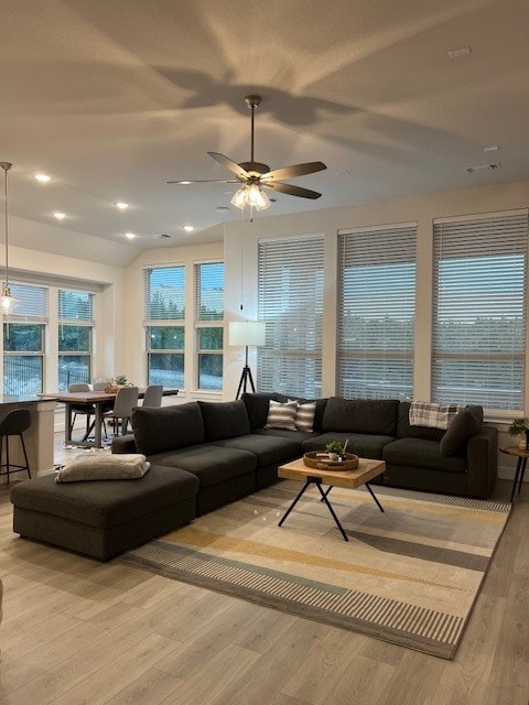 living room featuring light hardwood / wood-style flooring and ceiling fan