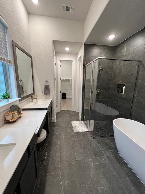 bathroom with vanity and separate shower and tub