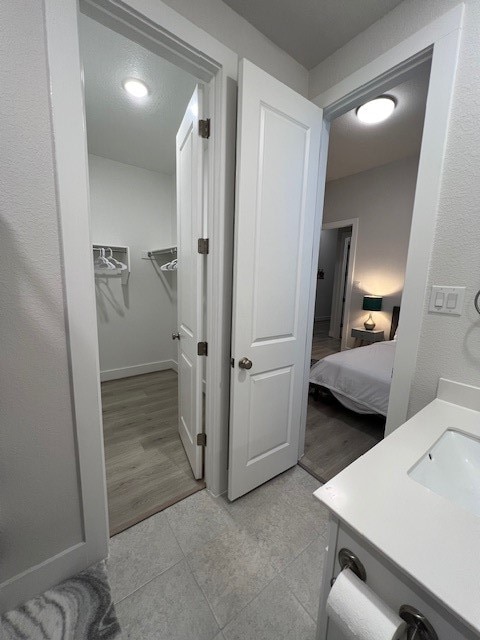 bathroom with vanity and wood-type flooring