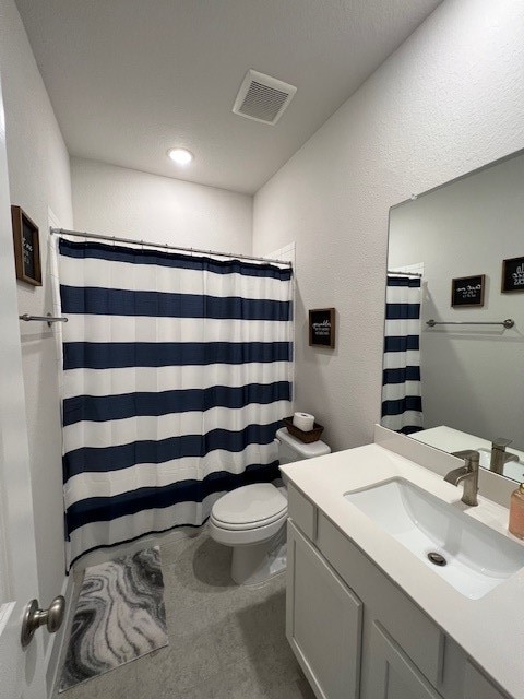 bathroom featuring vanity, toilet, and a shower with shower curtain