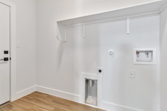 clothes washing area with hookup for an electric dryer, gas dryer hookup, hookup for a washing machine, and wood-type flooring