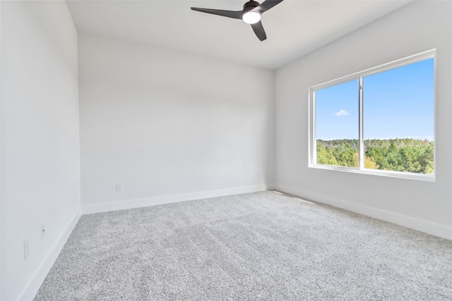 spare room featuring ceiling fan and carpet flooring