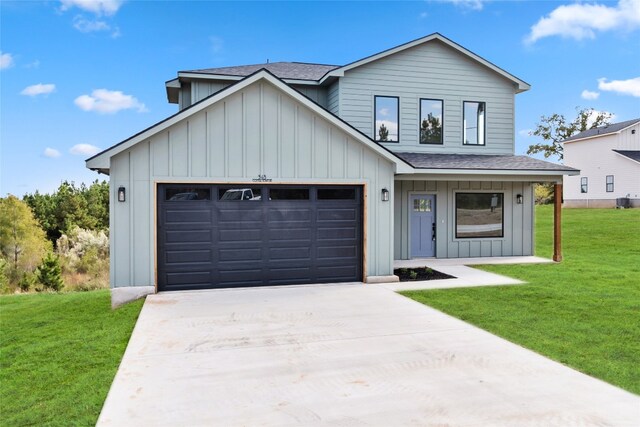 modern farmhouse featuring a front yard and a garage