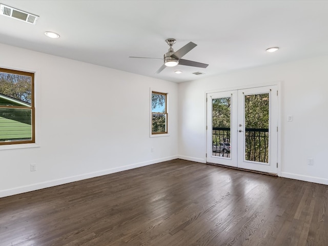 empty room with french doors, ceiling fan, and dark hardwood / wood-style flooring