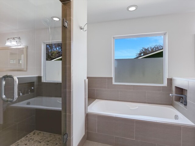 bathroom featuring separate shower and tub