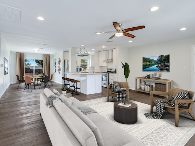 living room featuring ceiling fan and hardwood / wood-style floors