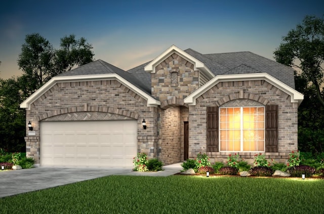 view of front of property with a yard and a garage