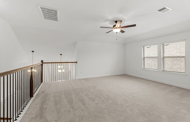 empty room featuring baseboards, a ceiling fan, light colored carpet, and visible vents