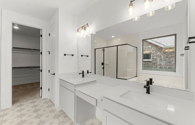 bathroom featuring double vanity, a sink, tile patterned floors, and a shower stall