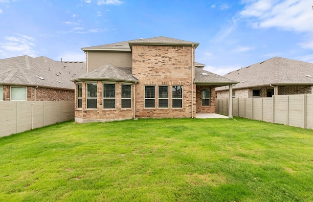 back of property featuring a patio, brick siding, a fenced backyard, and a lawn