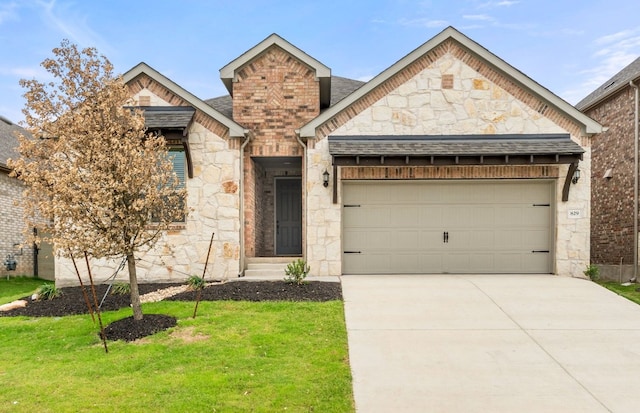 view of front of home with an attached garage, a front yard, stone siding, and concrete driveway