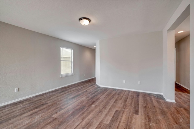 empty room with dark wood-type flooring