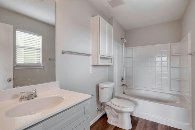 full bathroom with vanity, toilet, wood-type flooring, and shower / bathtub combination