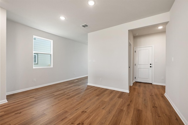 spare room with wood-type flooring