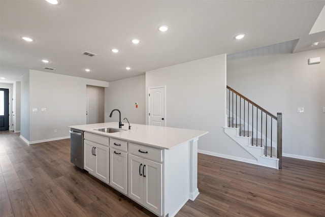 kitchen featuring sink, dark wood-type flooring, stainless steel dishwasher, a center island with sink, and white cabinets