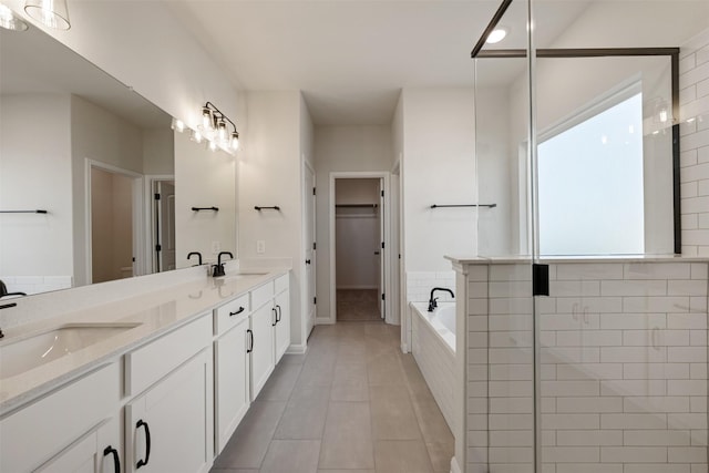 bathroom with shower with separate bathtub, vanity, and tile patterned floors