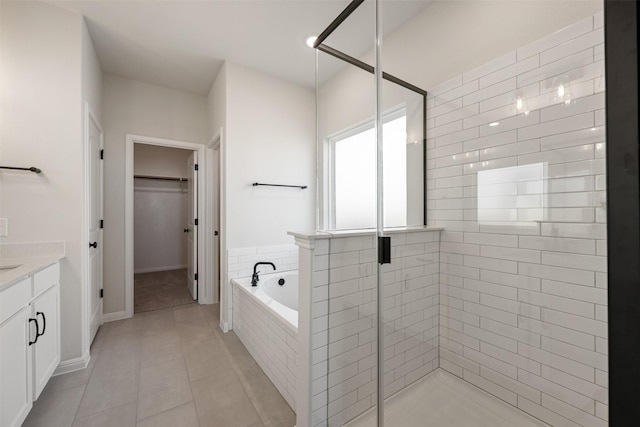 bathroom featuring vanity, separate shower and tub, and tile patterned floors