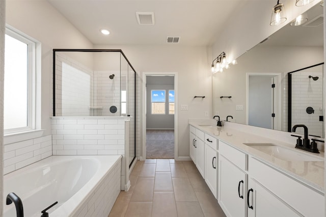 bathroom with tile patterned flooring, shower with separate bathtub, and vanity