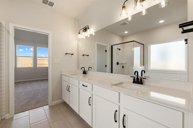 bathroom with tile patterned floors, vanity, and an enclosed shower