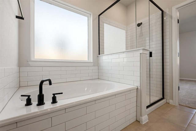 bathroom with tile patterned floors, plus walk in shower, and a wealth of natural light