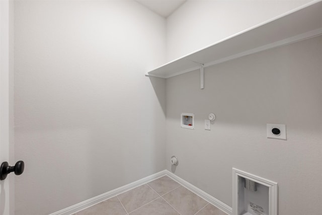 laundry area with electric dryer hookup, gas dryer hookup, light tile patterned floors, and washer hookup