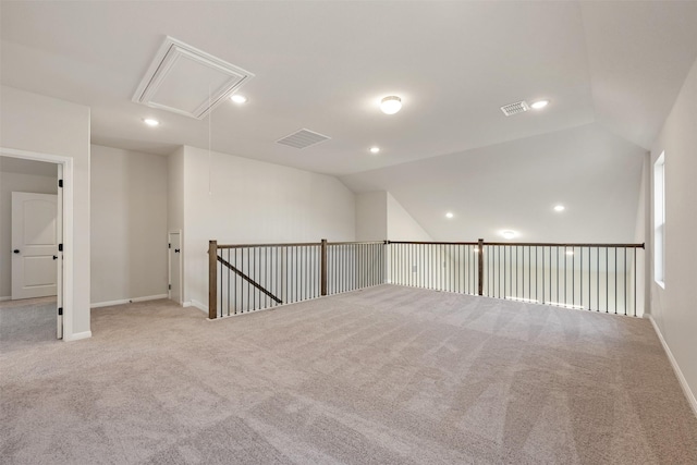 spare room with lofted ceiling and light carpet