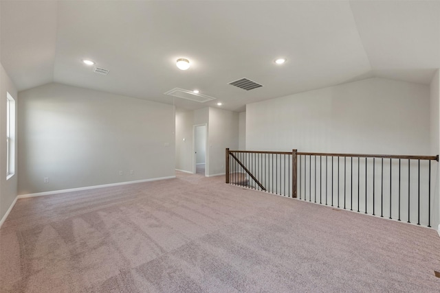 carpeted spare room with lofted ceiling