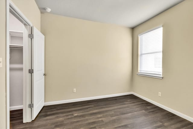 unfurnished bedroom featuring dark wood-type flooring