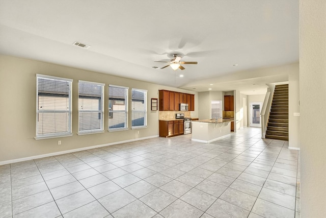 unfurnished living room with ceiling fan and light tile patterned flooring