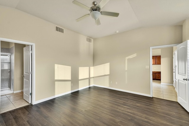 spare room featuring lofted ceiling, dark hardwood / wood-style floors, and ceiling fan