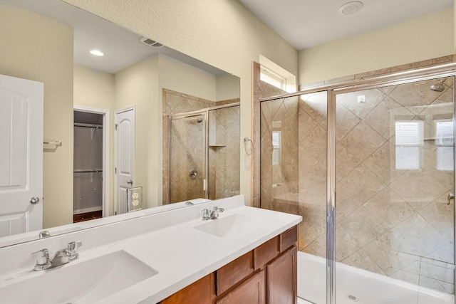 bathroom featuring vanity and a shower with shower door