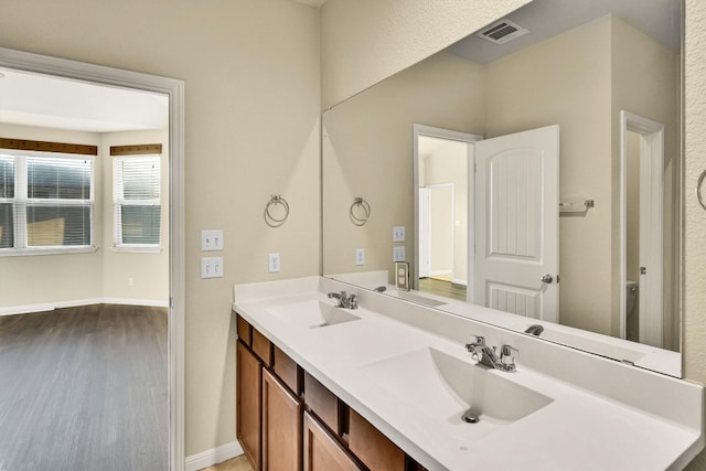 bathroom with vanity, toilet, and wood-type flooring