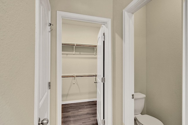 bathroom featuring toilet and wood-type flooring