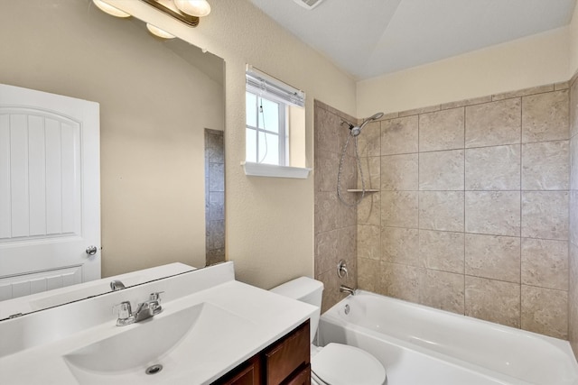 full bathroom with vanity, vaulted ceiling, tiled shower / bath combo, and toilet