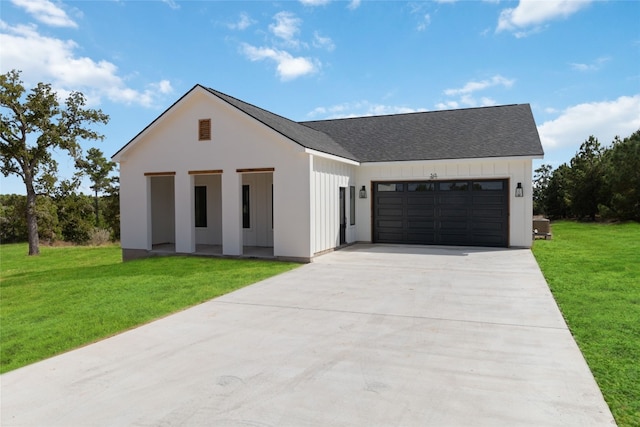 view of front of property with a front lawn and a garage