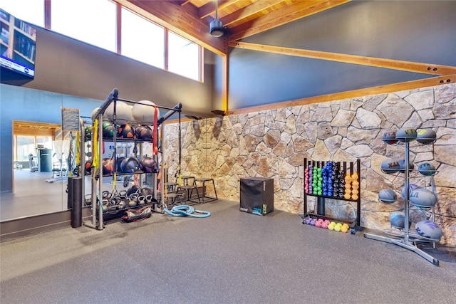 workout area featuring high vaulted ceiling and carpet