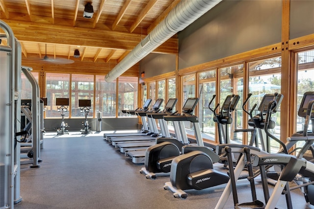 gym featuring vaulted ceiling and wooden ceiling